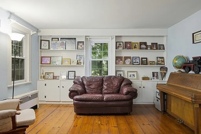 a living room with furniture and a book shelf