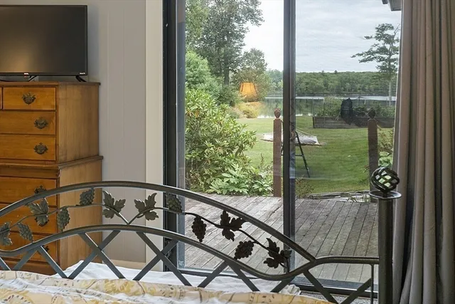 a view of a balcony with chair and iron gate