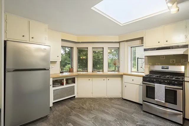 a kitchen with white cabinets and white appliances