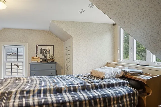 an aerial view of a house with a yard and trees