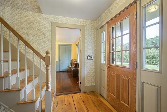a view of a hallway with wooden floor and entryway