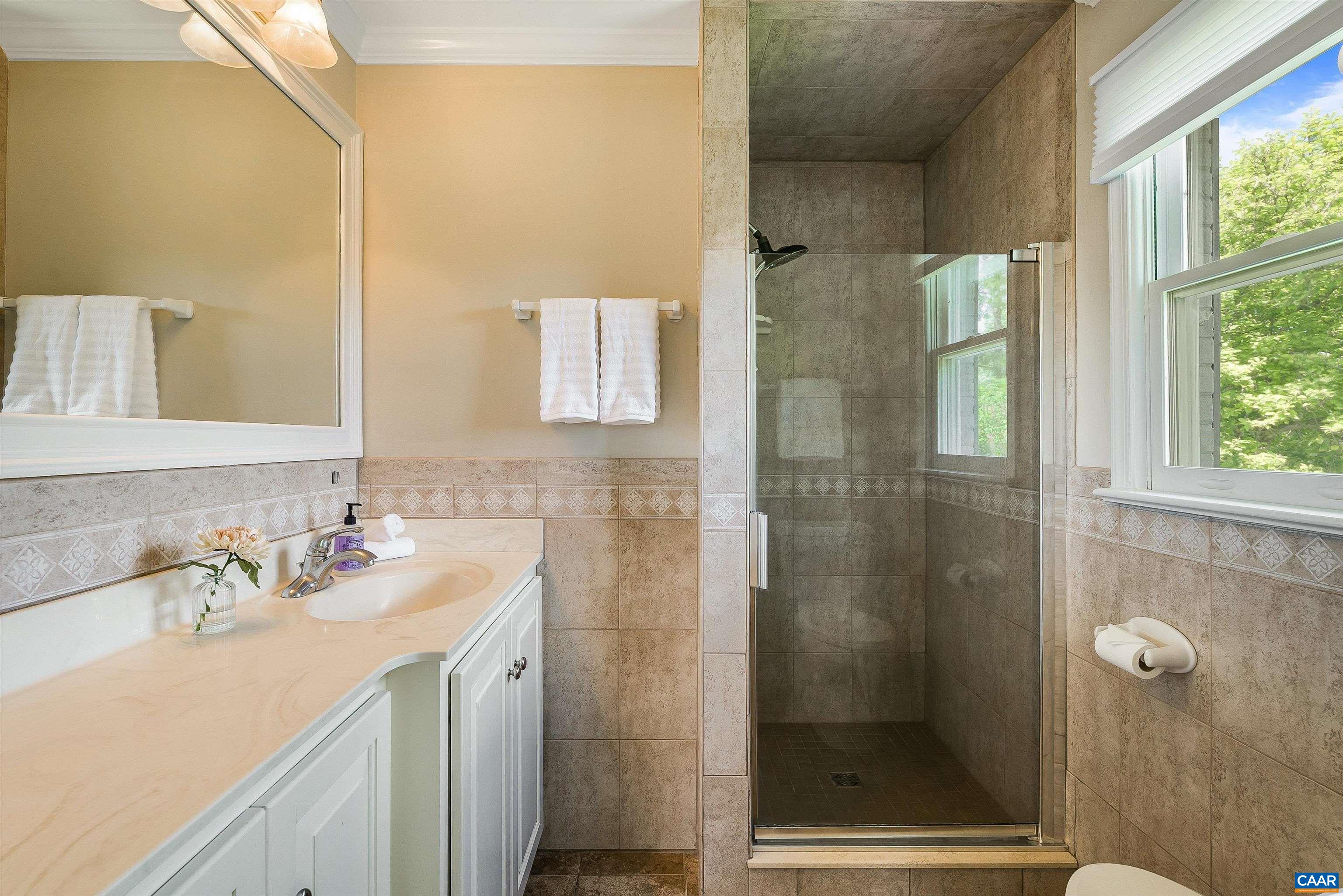 1571 Duke Road Waynesboro, VA 22980 - Photo 32 of 75 a bathroom with a shower sink and mirror