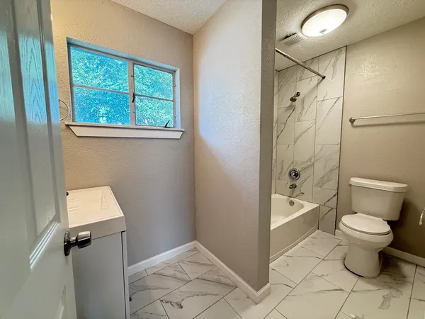 a bathroom with a toilet sink and a shower