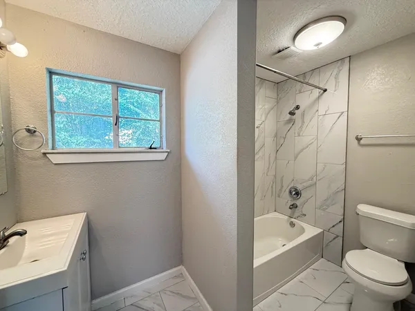 a bathroom with a bathtub toilet and sink