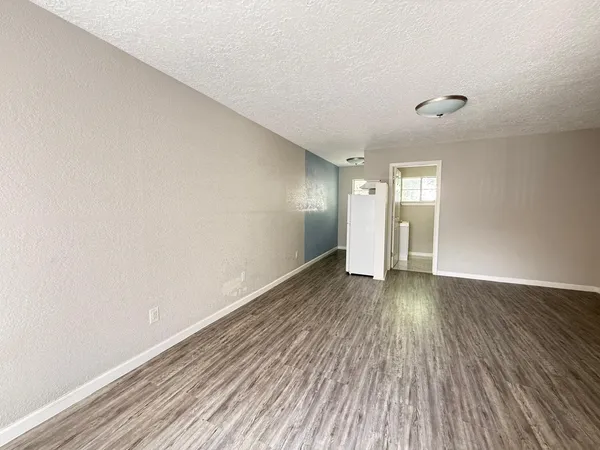 a view of an empty room and wooden floor
