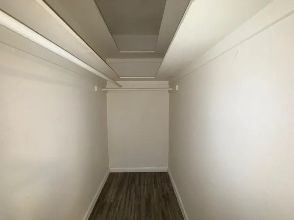 a view of hallway with wooden floor
