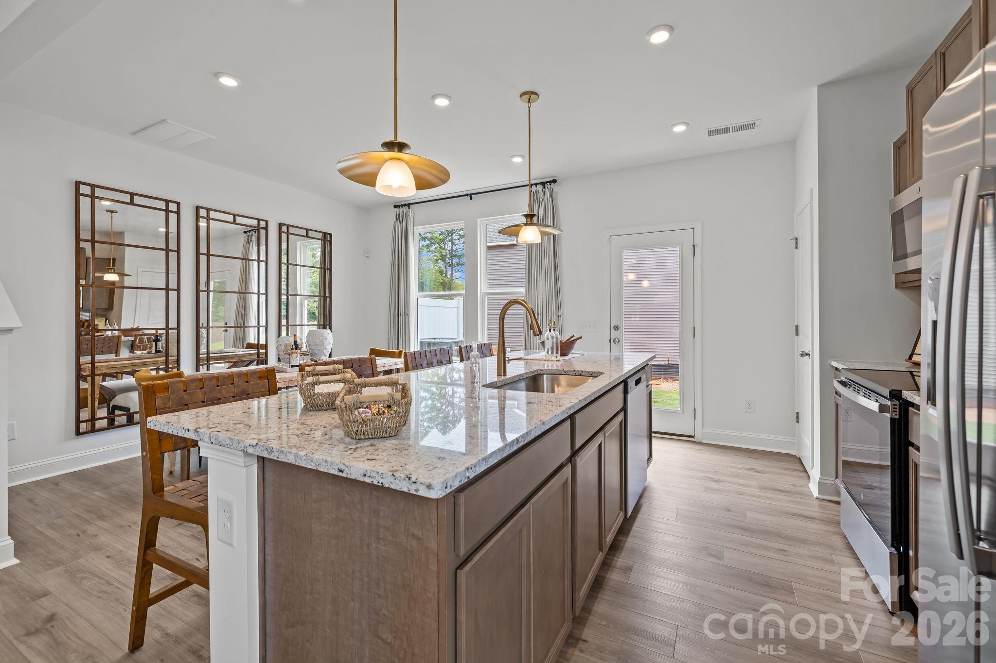7709 Ethora Way Charlotte, NC 28216 - Photo 14 of 33 a kitchen with stainless steel appliances granite countertop a sink a stove and a refrigerator