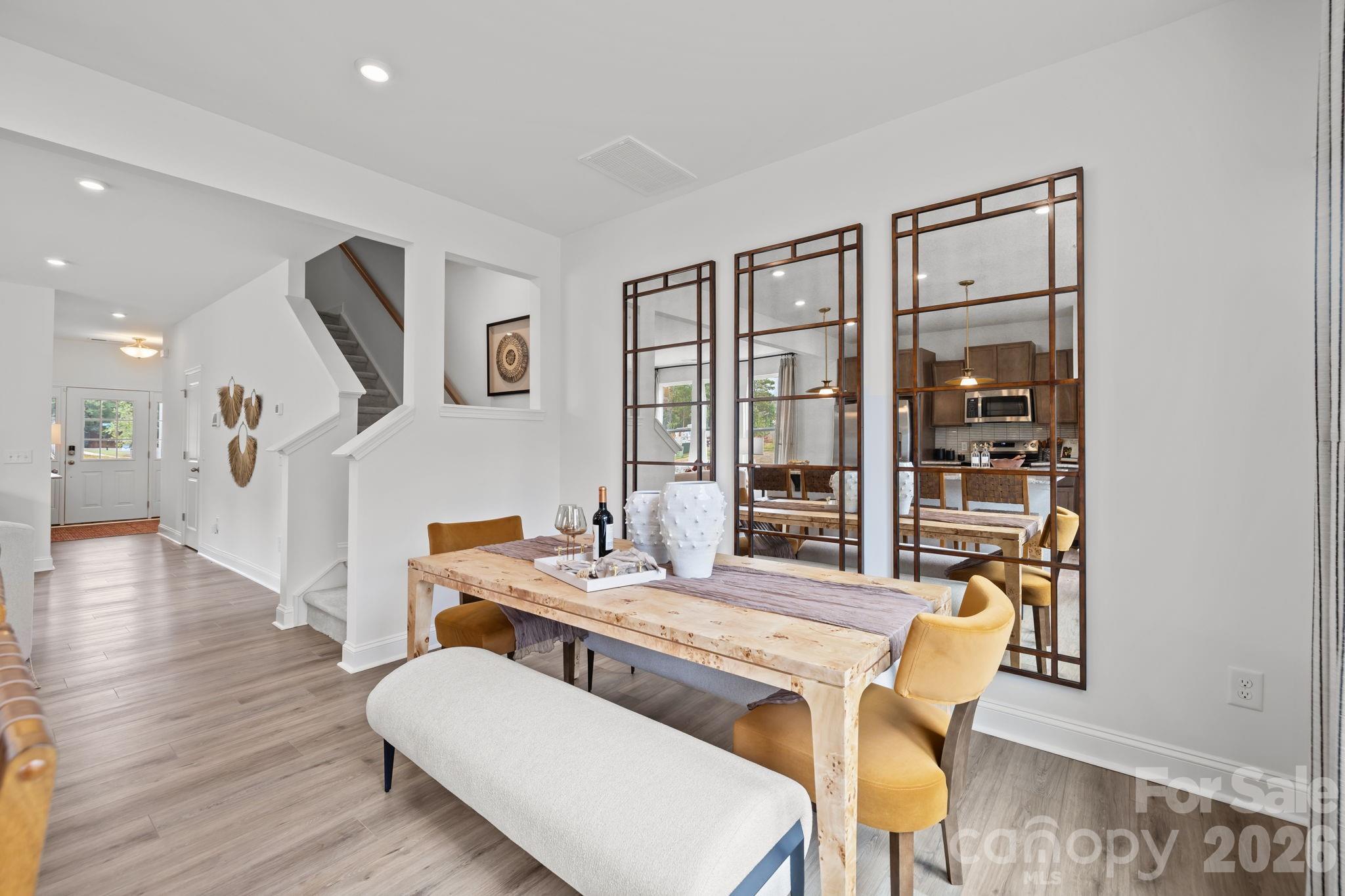 7709 Ethora Way Charlotte, NC 28216 - Photo 16 of 33 a dining room with furniture and wooden floor