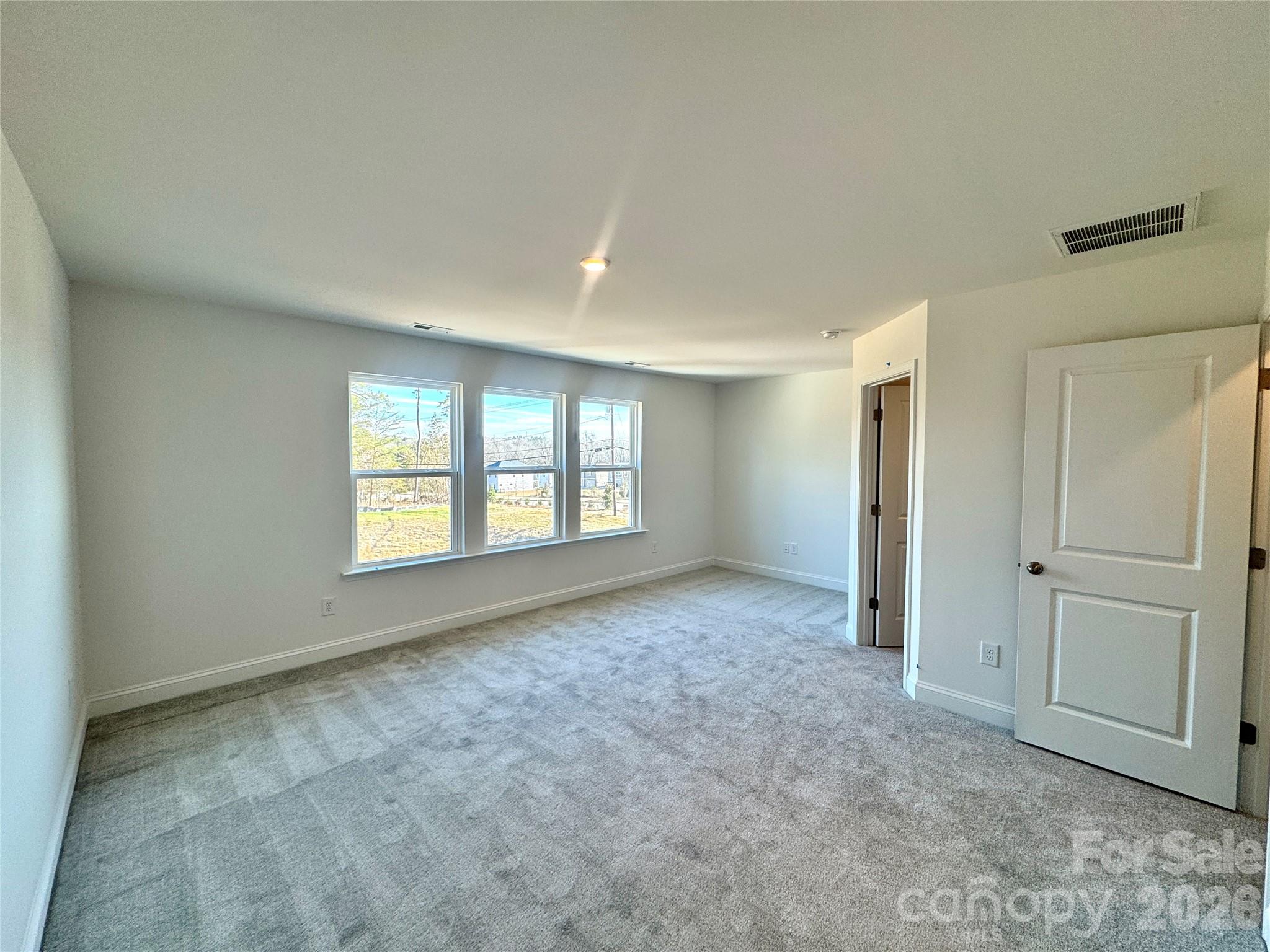 7709 Ethora Way Charlotte, NC 28216 - Photo 19 of 33 a view of an empty room with a window