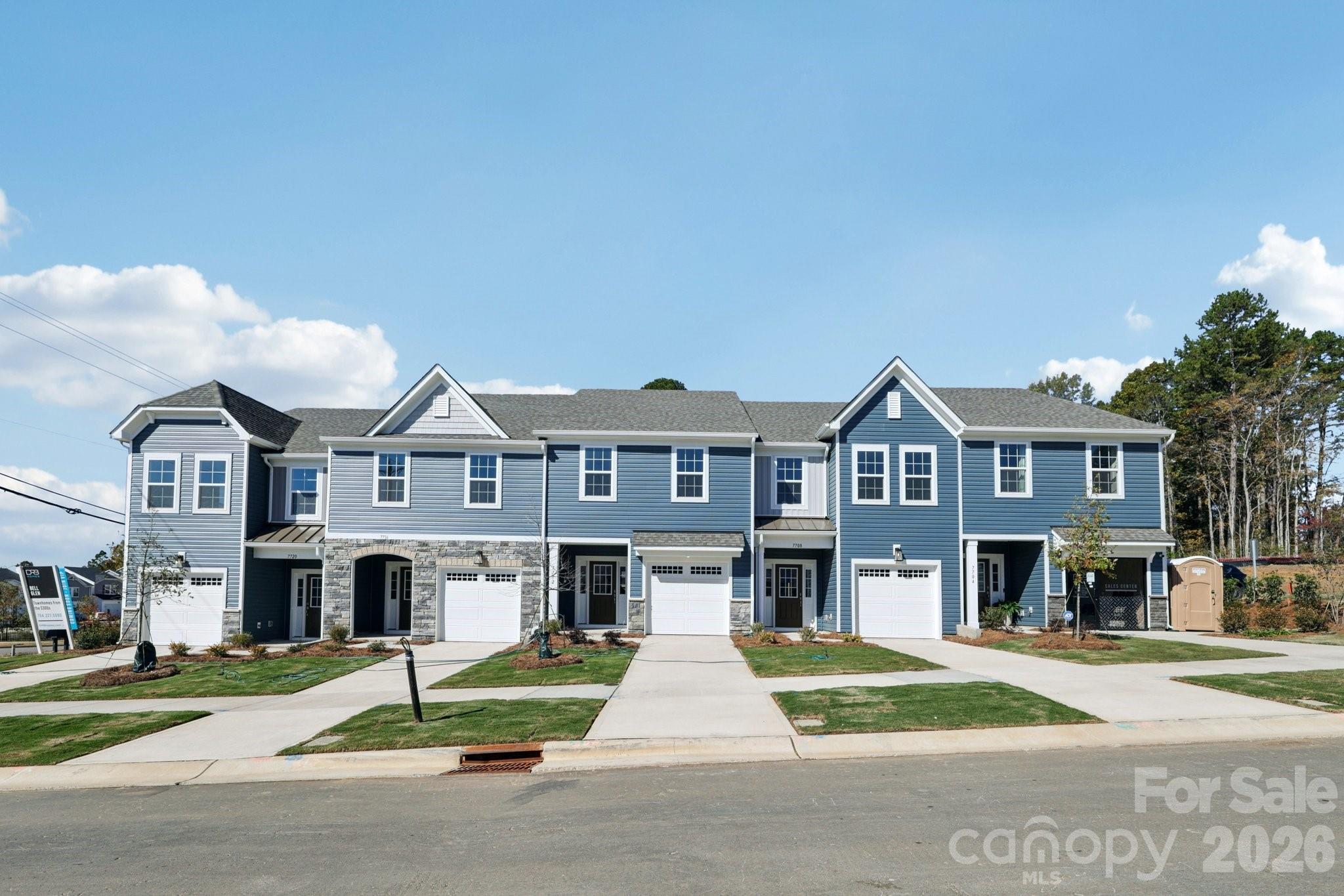 7709 Ethora Way Charlotte, NC 28216 - Photo 2 of 33 a front view of residential houses with yard and road