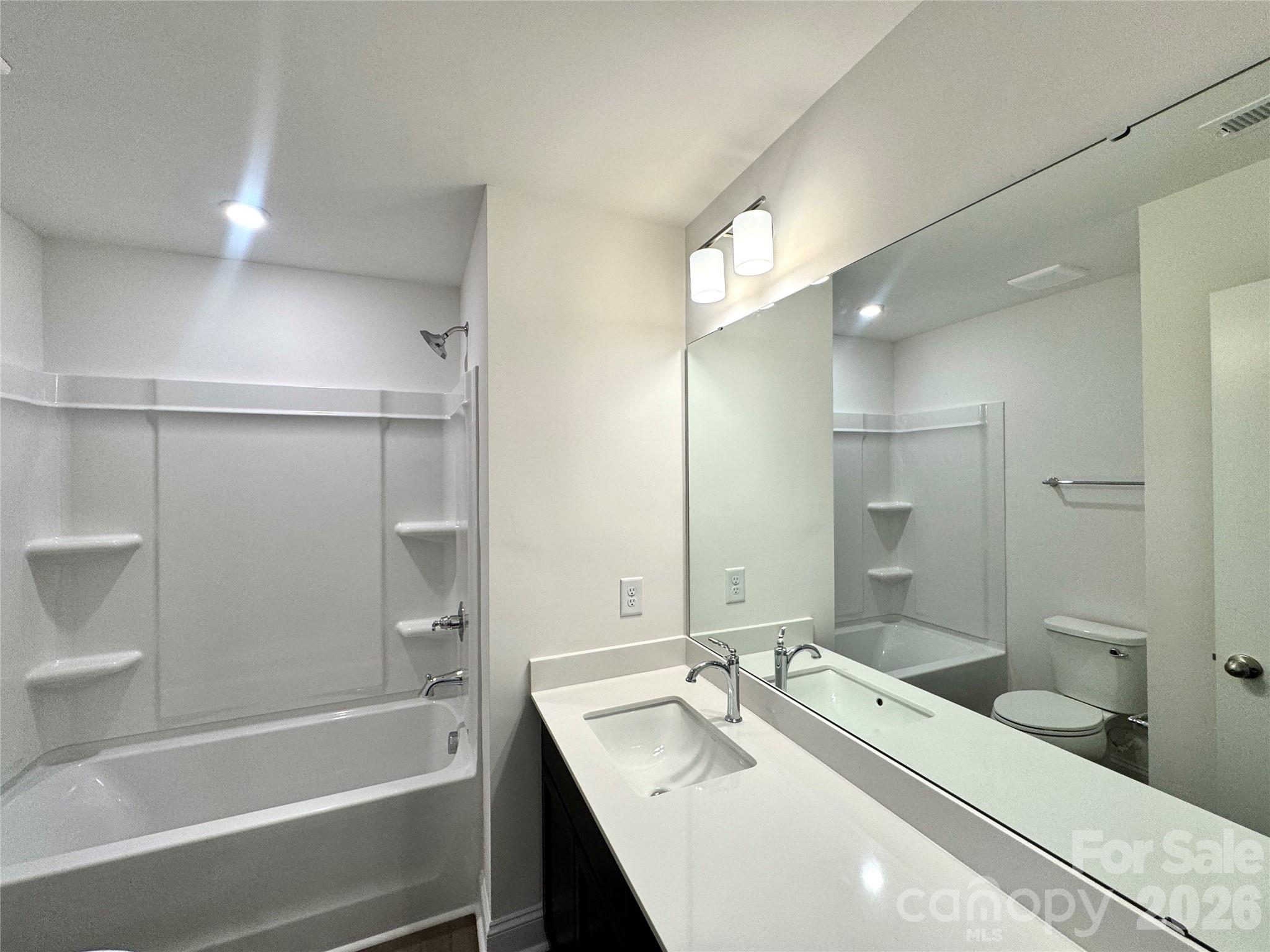 7709 Ethora Way Charlotte, NC 28216 - Photo 23 of 33 a bathroom with a tub sink and mirror