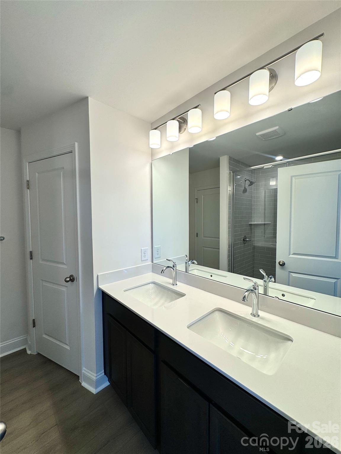 7709 Ethora Way Charlotte, NC 28216 - Photo 27 of 33 a bathroom with a double vanity sink and a mirror