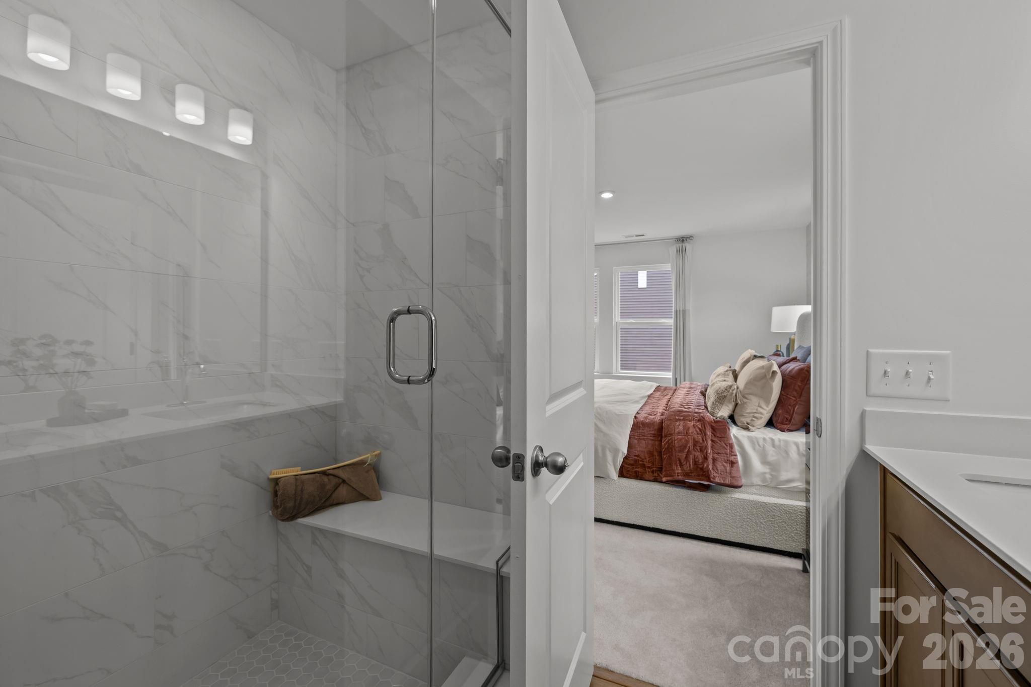 7709 Ethora Way Charlotte, NC 28216 - Photo 30 of 33 a en suite bathroom with a granite countertop sink and shower