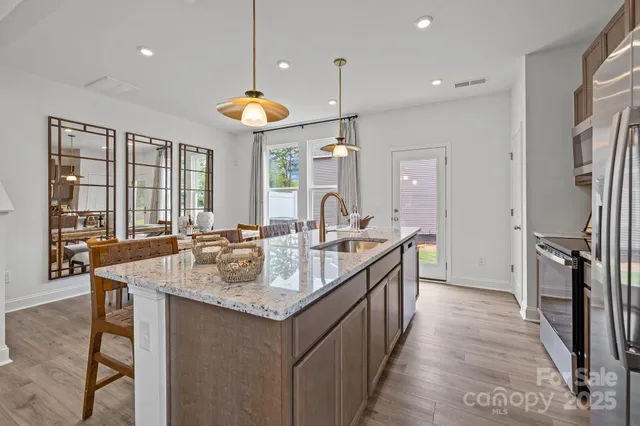 a kitchen with counter top space sink and refrigerator