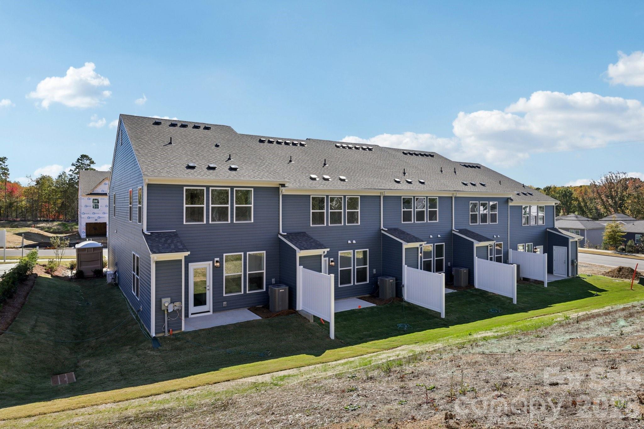 7709 Ethora Way Charlotte, NC 28216 - Photo 3 of 33 a front view of a house with a yard