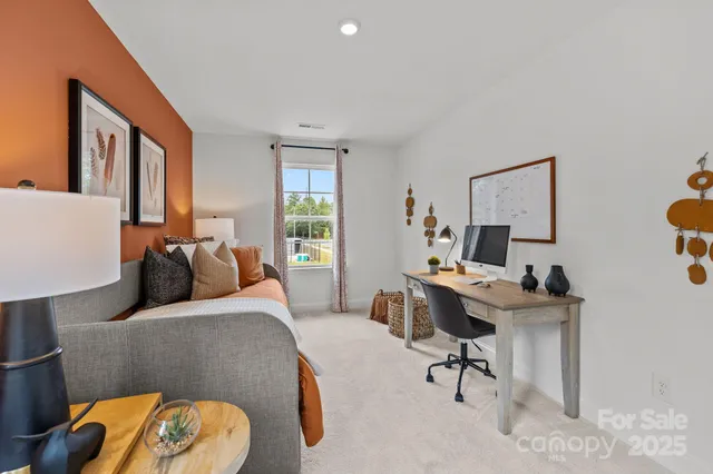 a bedroom with furniture and a window