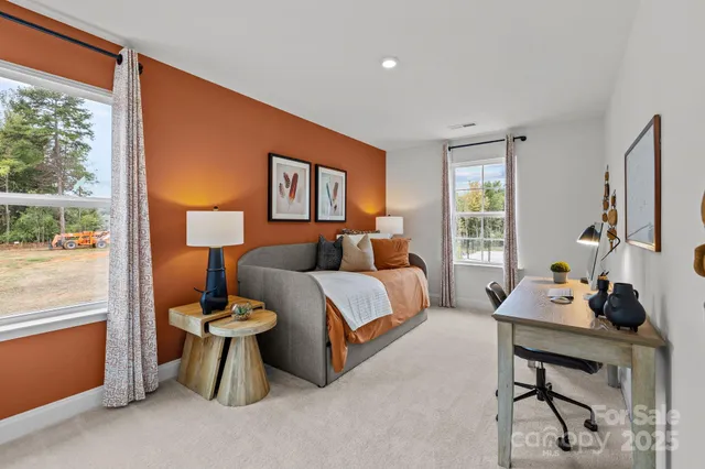 a bedroom with furniture and a window