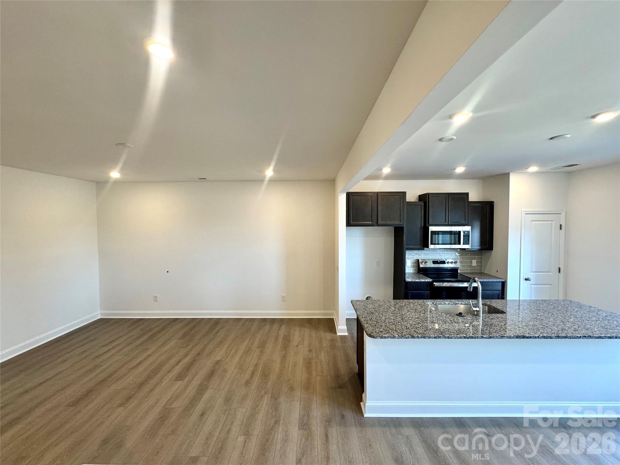 7709 Ethora Way Charlotte, NC 28216 - Photo 10 of 33 a view of kitchen with granite countertop stainless steel appliances refrigerator sink microwave and stove
