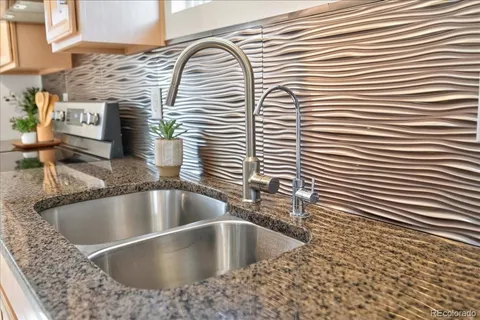 a view of a kitchen counter top a sink and wooden floor