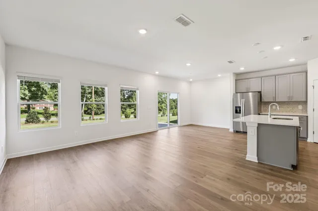 a view of kitchen with wooden floor electronic appliances and window