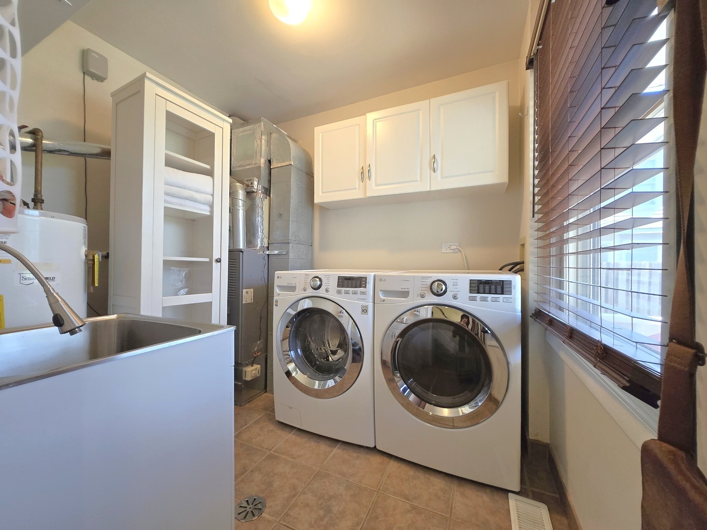 358 Westgate Terrace Streamwood, IL 60107 - Photo 17 of 39 a utility room with stainless steel appliances washer and dryer