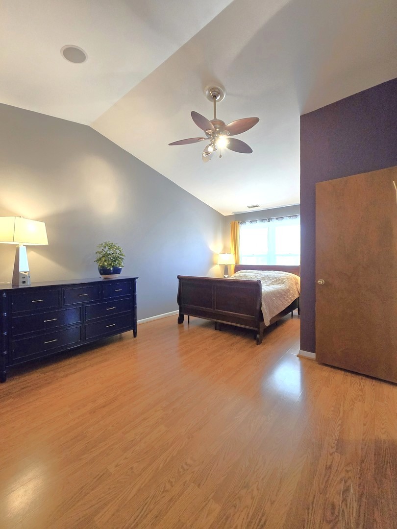 358 Westgate Terrace Streamwood, IL 60107 - Photo 20 of 39 a room with a bed and a chandelier