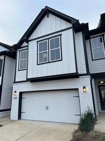 a front view of a house with garage