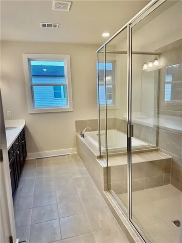 a bathroom with a shower and a bathtub