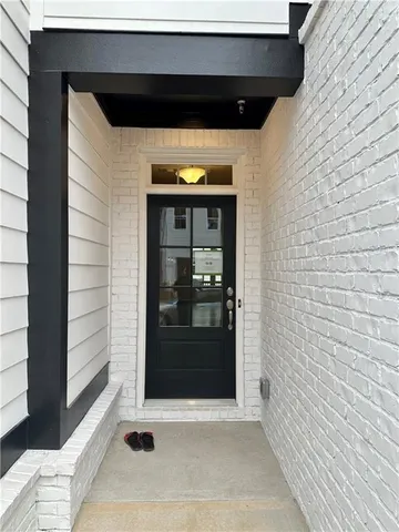 a living room with stainless steel appliances kitchen island granite countertop a stove and a wooden floor