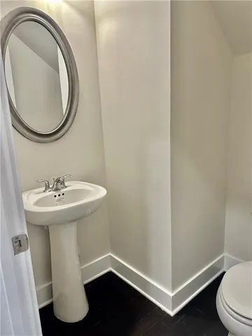 a kitchen with stove and wooden floor