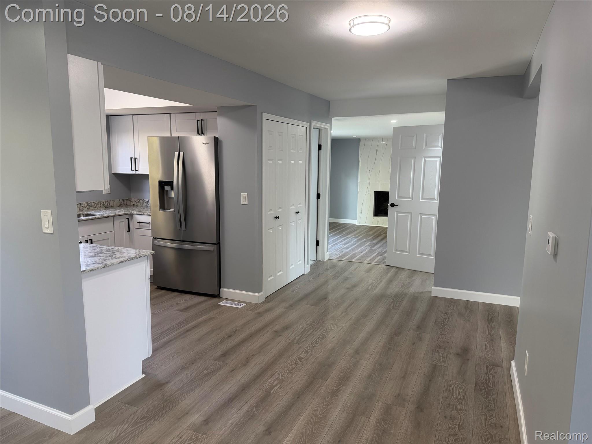 20698 Coachwood Road Riverview, MI 48193 - Photo 7 of 37 Open-concept main living area featuring wood-finish flooring, light gray wall tones, and white trim