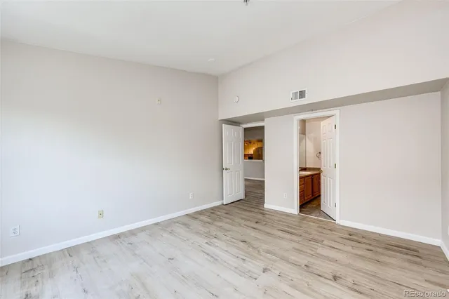 a view of a room with wooden floor and closet