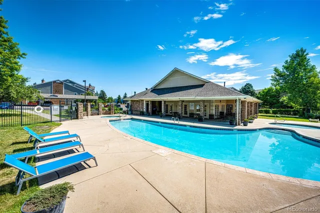 a house with swimming pool in front of it