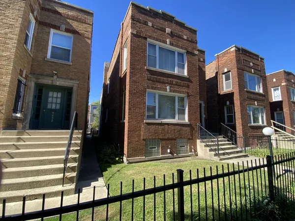 a view of a brick building with many windows