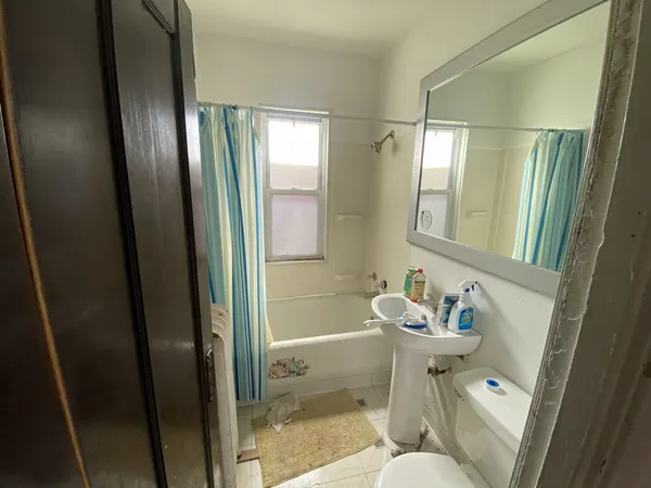 a bathroom with a sink mirror vanity and toilet