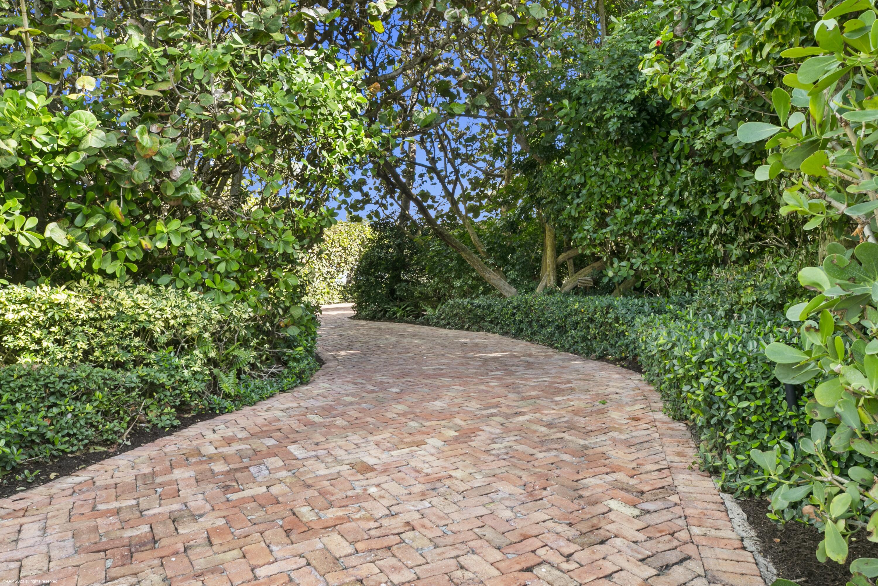 107 North Beach Road Jupiter Island, FL 33455 - Photo 12 of 55 a view of a pathway with a yard