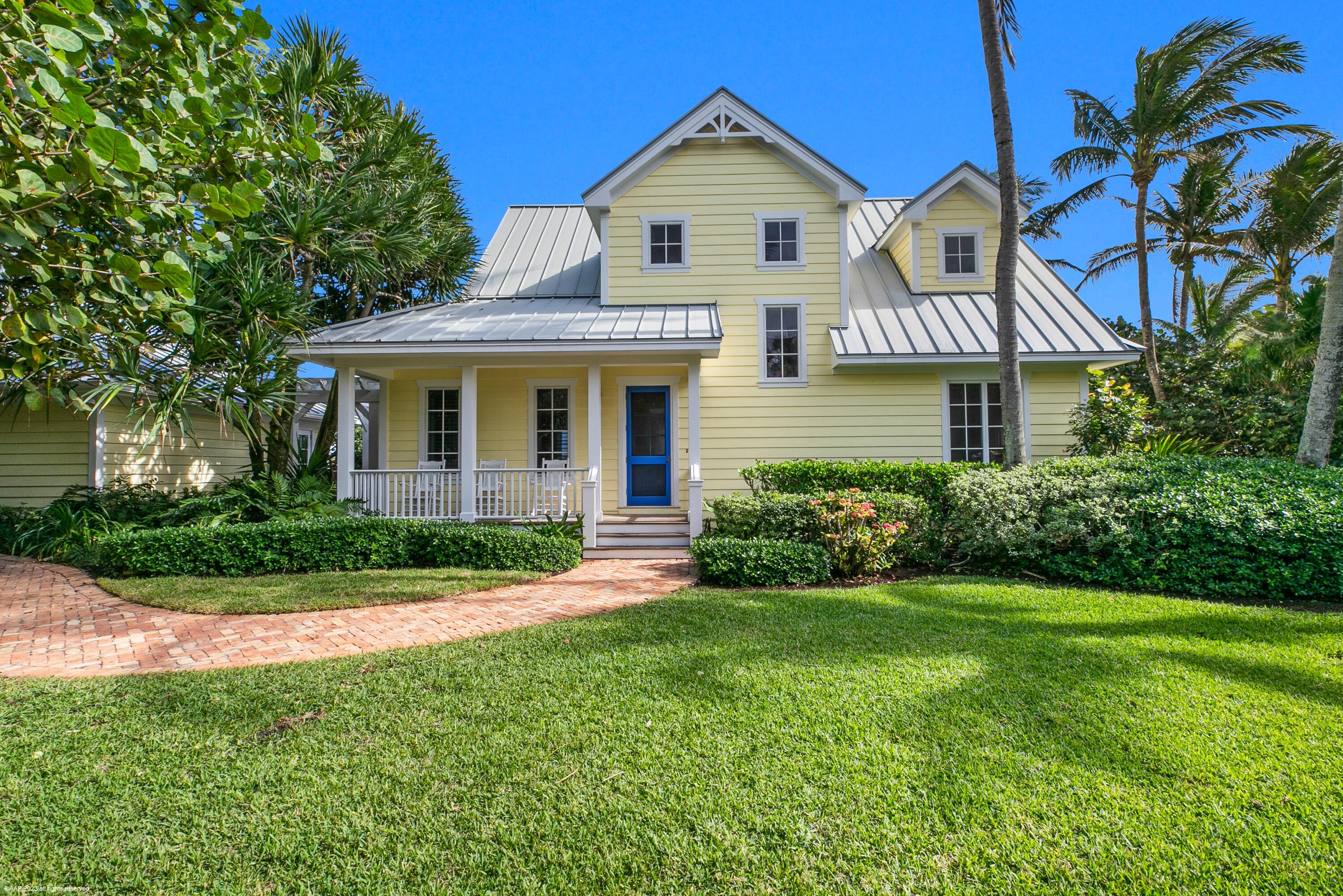 107 North Beach Road Jupiter Island, FL 33455 - Photo 14 of 55 a front view of a house with a yard and garage