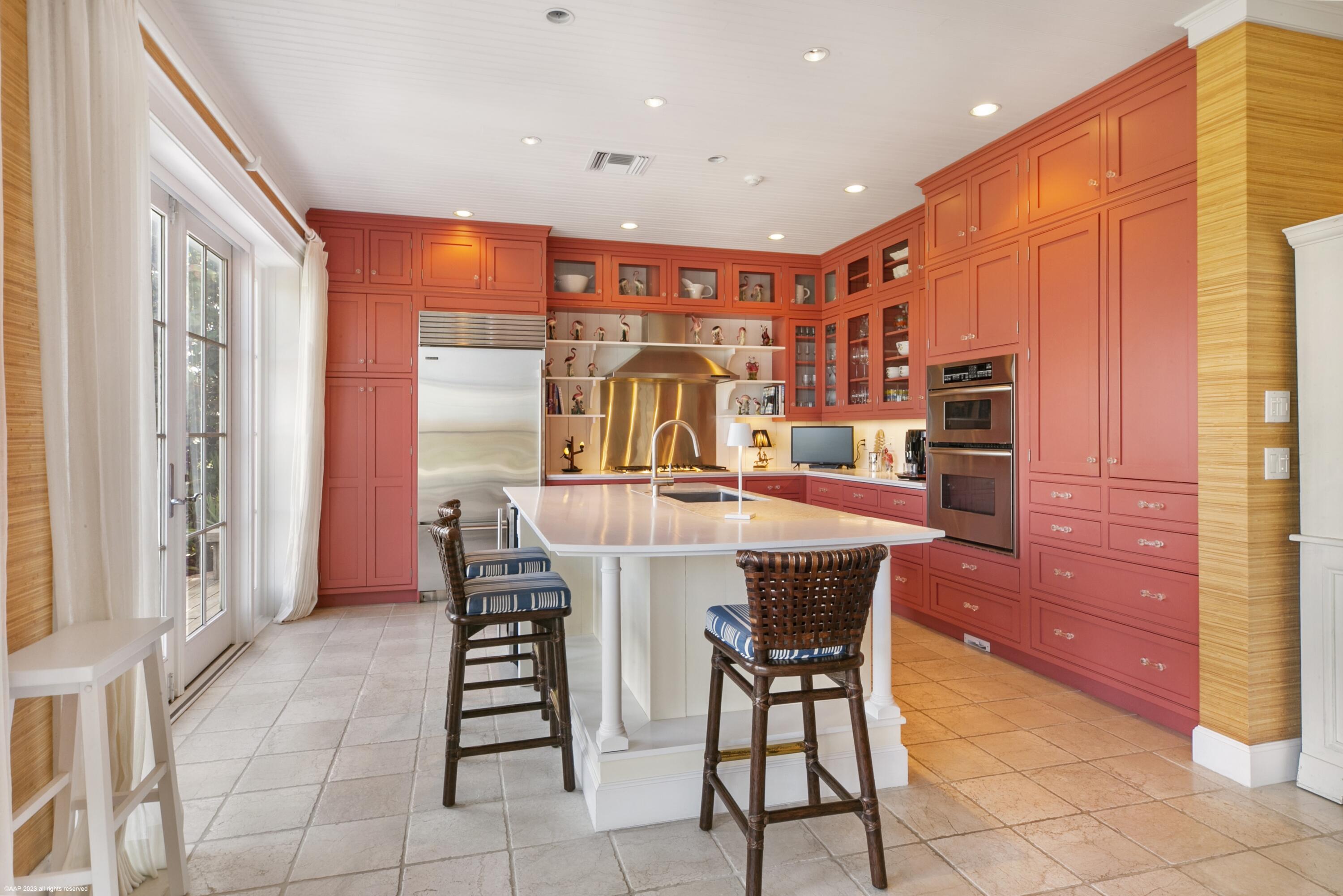 107 North Beach Road Jupiter Island, FL 33455 - Photo 23 of 55 a dining hall with stainless steel appliances a dining table and chairs with wooden floor