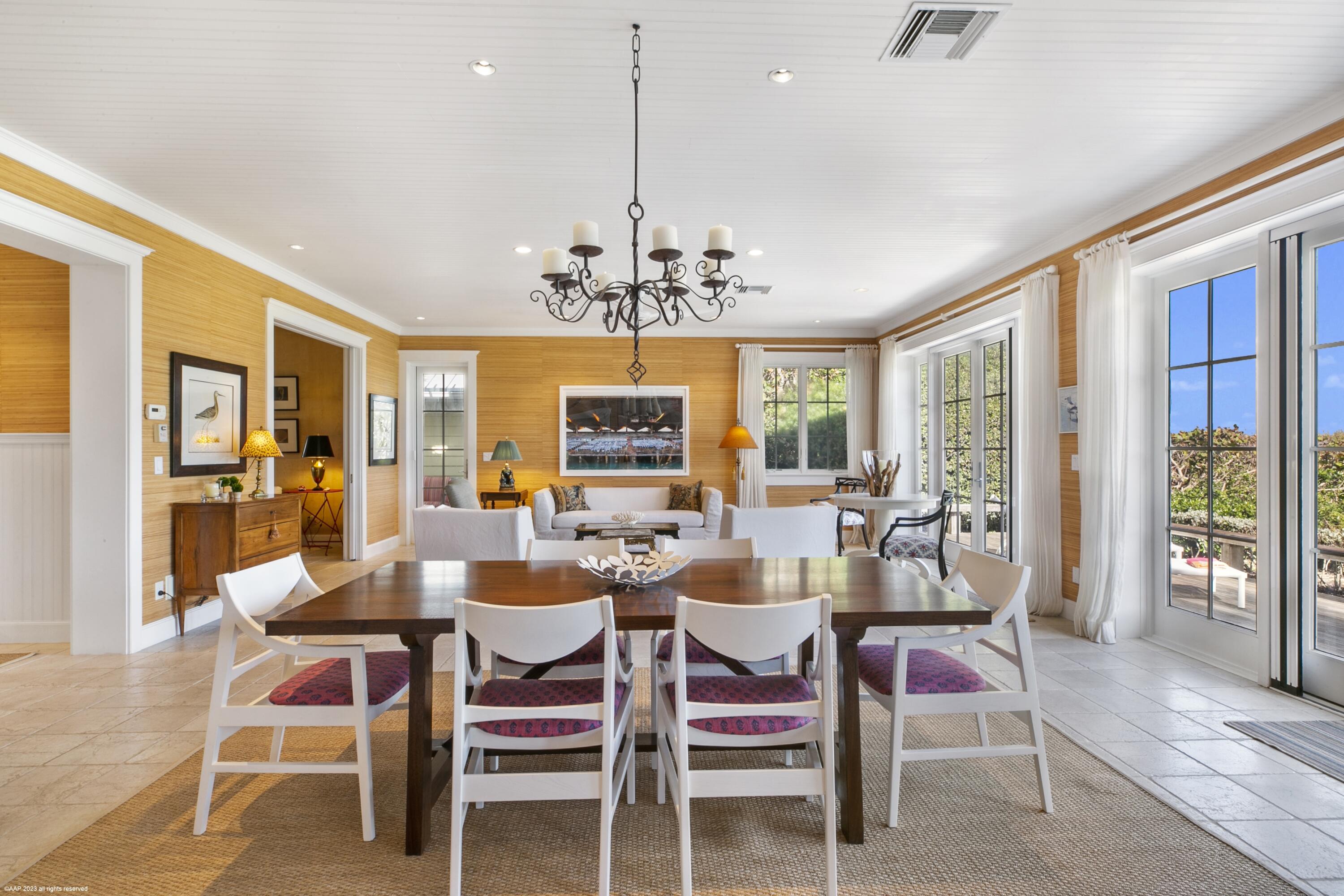 107 North Beach Road Jupiter Island, FL 33455 - Photo 25 of 55 a view of a dining room with furniture wooden floor and chandelier