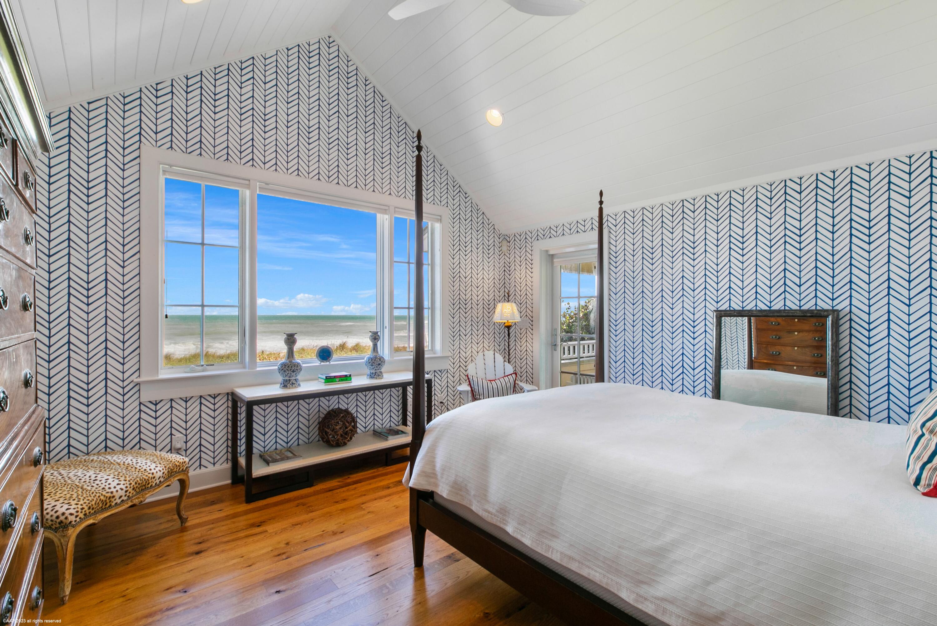 107 North Beach Road Jupiter Island, FL 33455 - Photo 32 of 55 a bedroom with a bed and a table