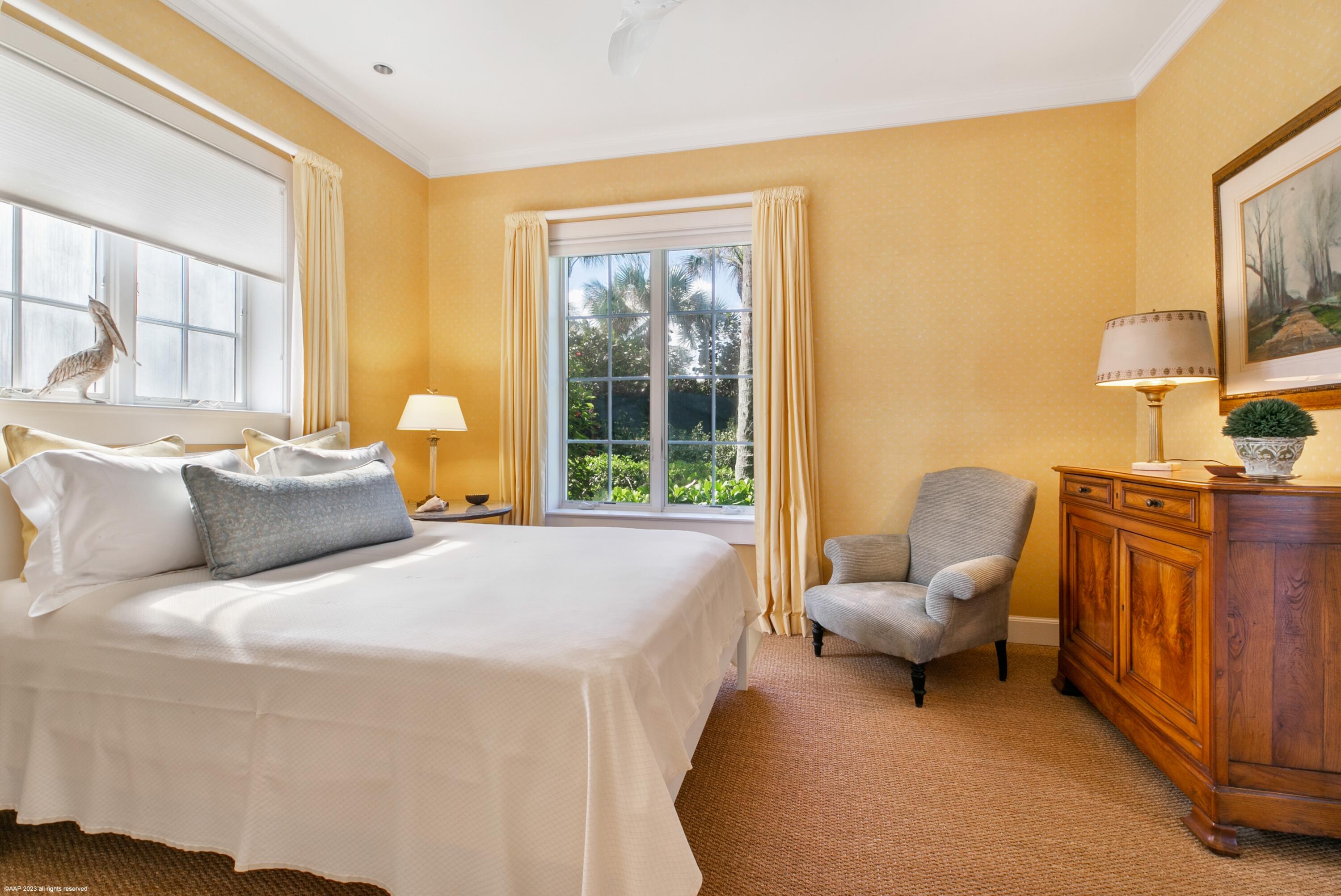 107 North Beach Road Jupiter Island, FL 33455 - Photo 35 of 55 a spacious bedroom with a bed and wooden floor