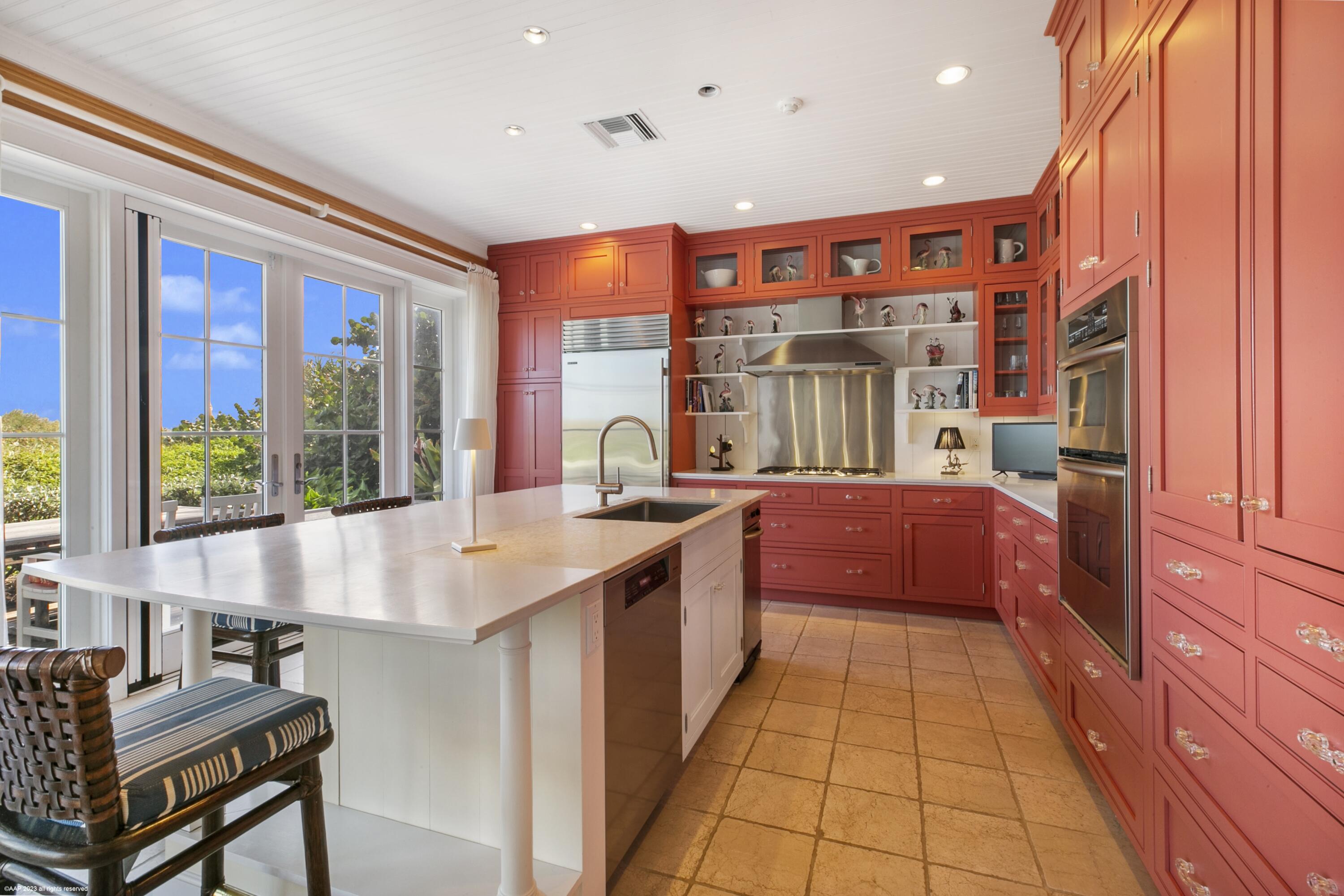 107 North Beach Road Jupiter Island, FL 33455 - Photo 4 of 55 a large kitchen with stainless steel appliances granite countertop a large window and a counter top space