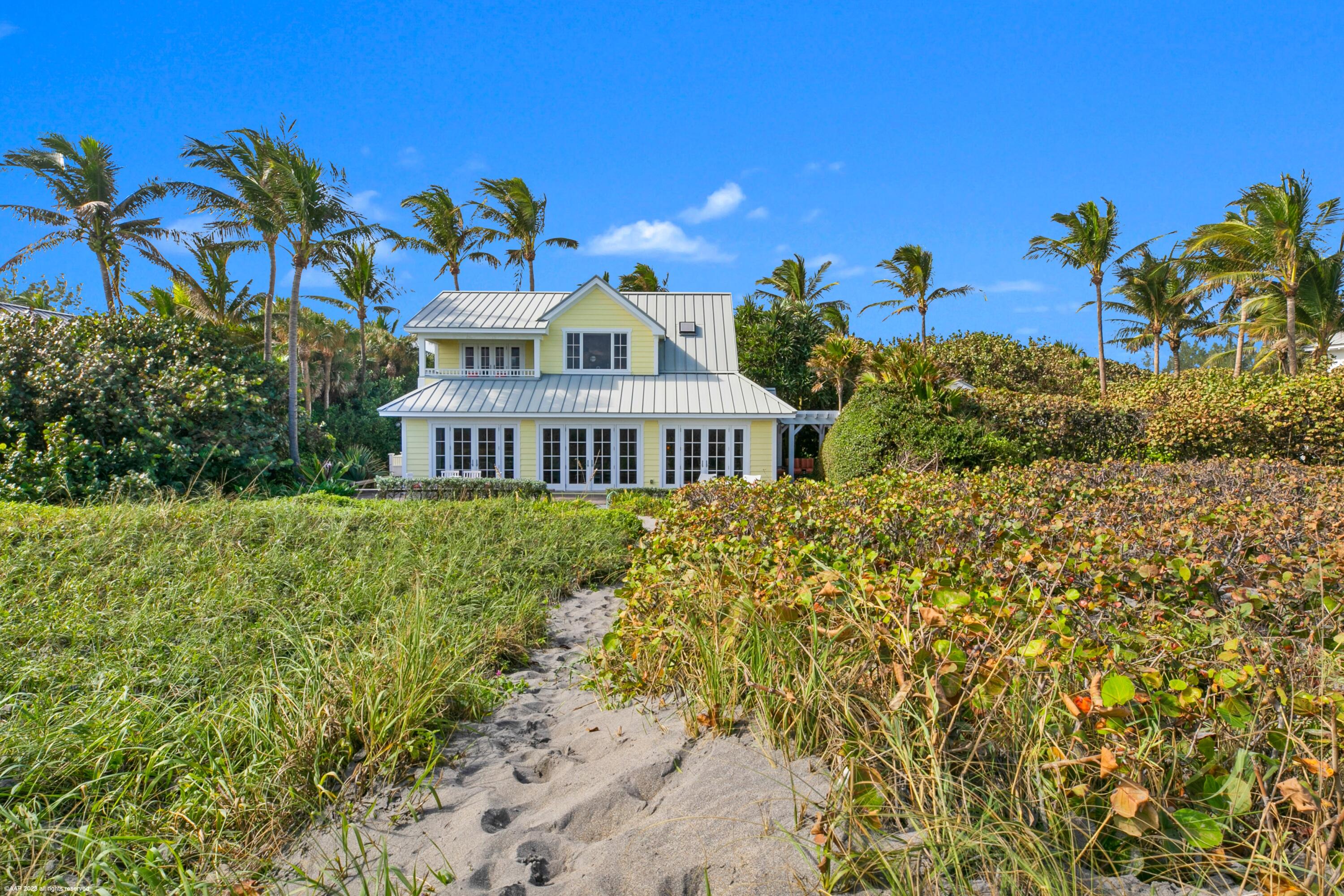 107 North Beach Road Jupiter Island, FL 33455 - Photo 41 of 55 a front view of a house with a yard