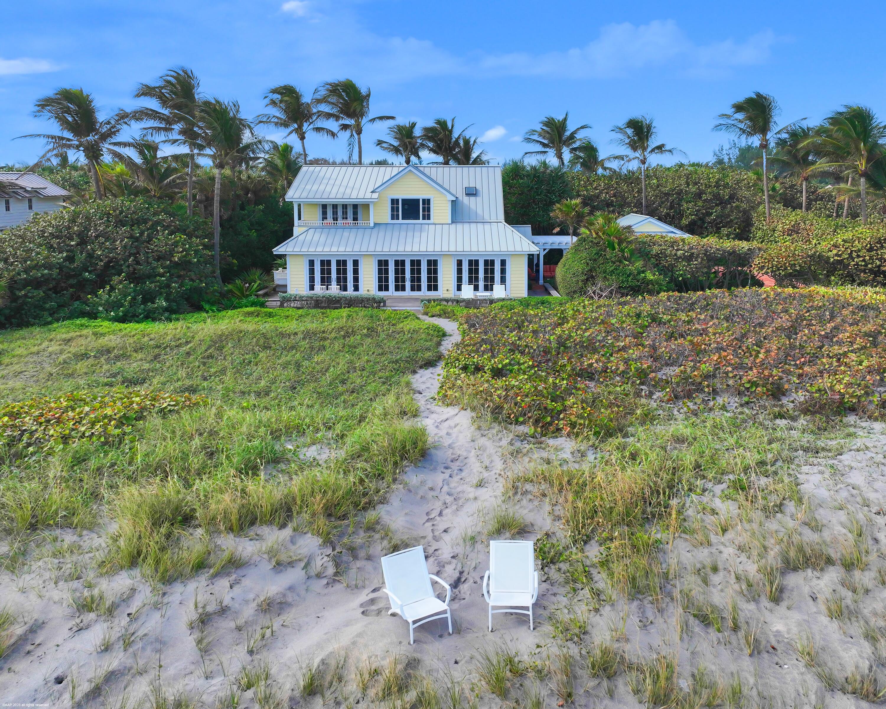 107 North Beach Road Jupiter Island, FL 33455 - Photo 44 of 55 a view of a house with a garden