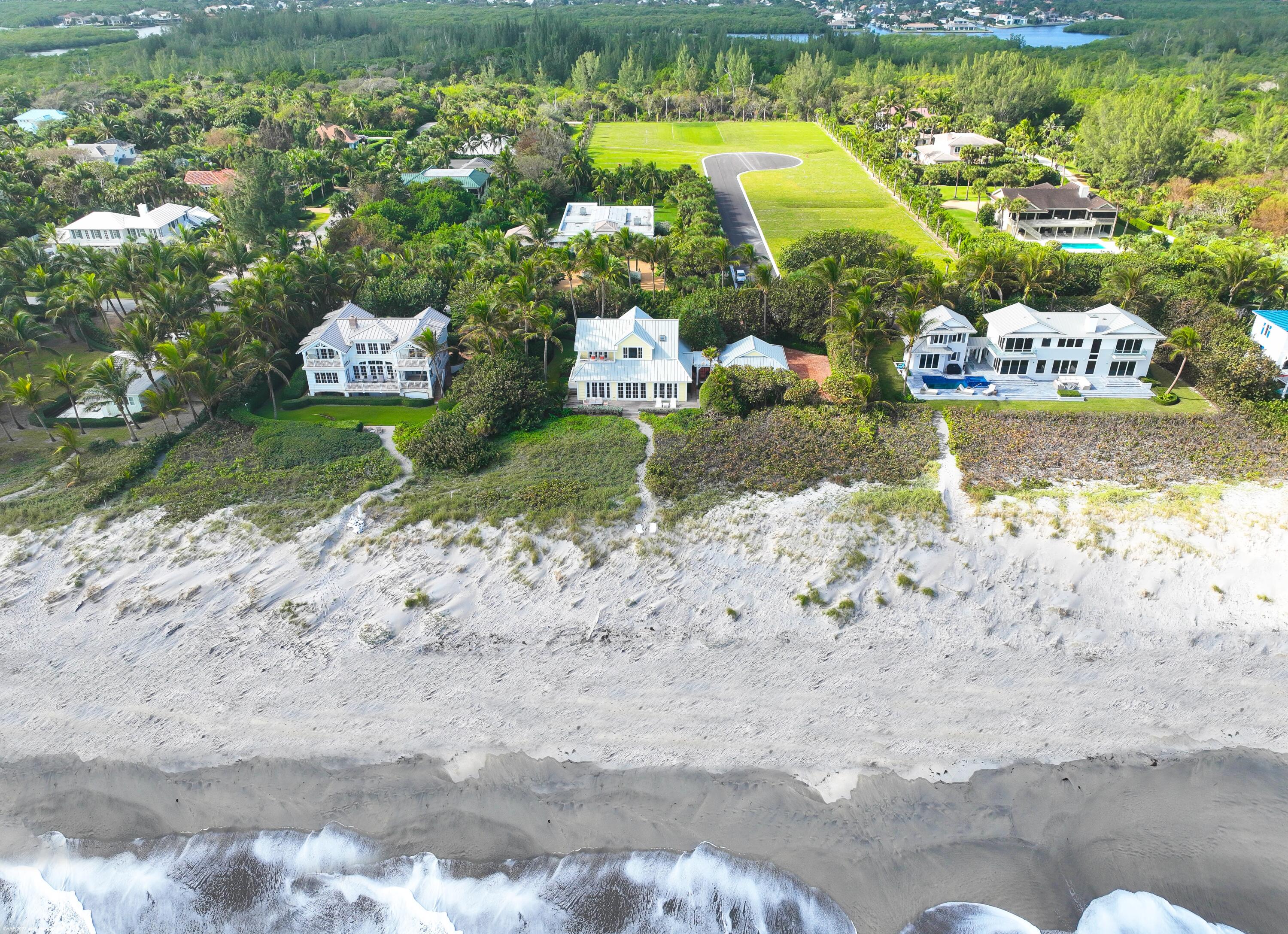 107 North Beach Road Jupiter Island, FL 33455 - Photo 47 of 55 a front view of a house with a yard