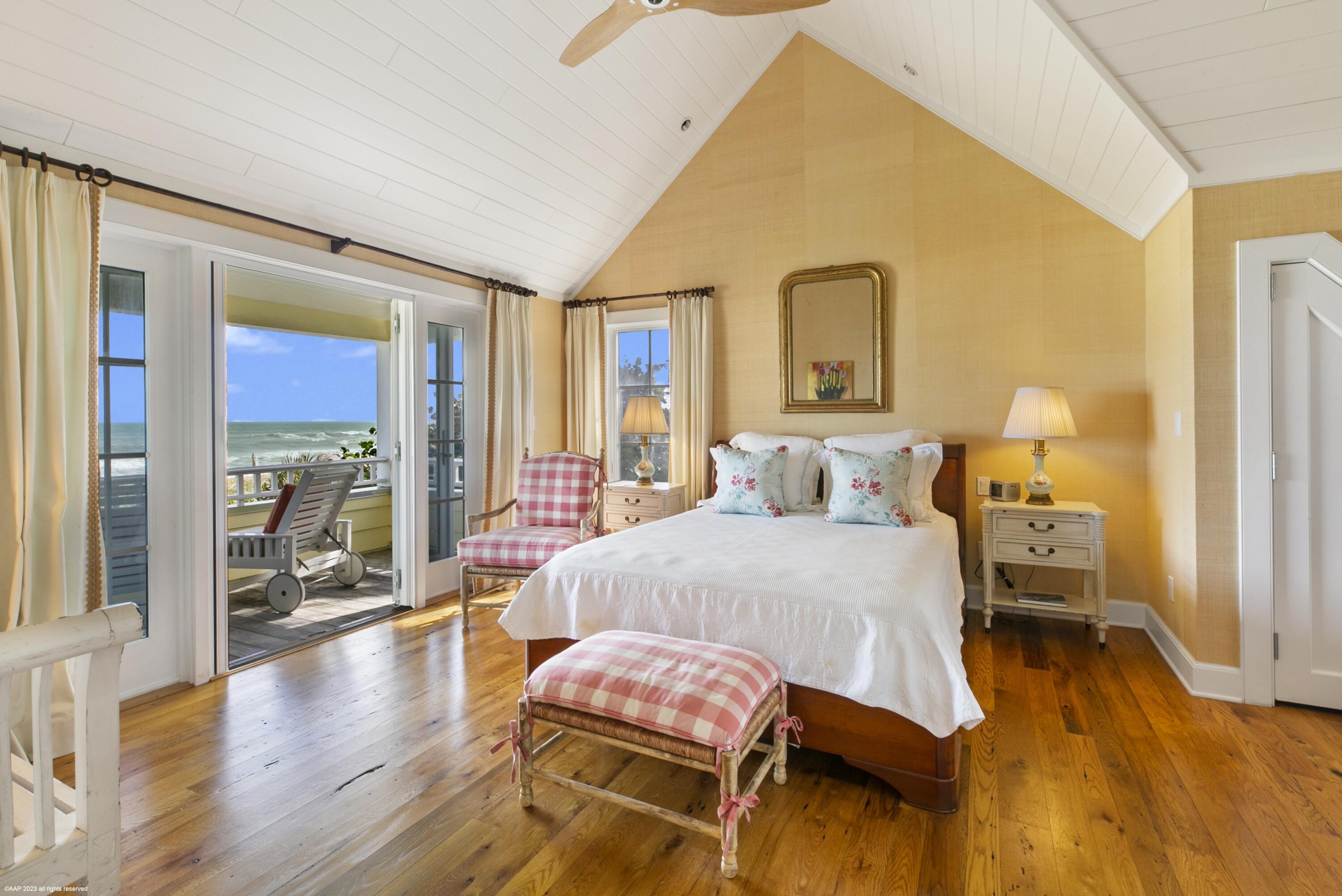 107 North Beach Road Jupiter Island, FL 33455 - Photo 5 of 55 a spacious bedroom with a bed and wooden floor