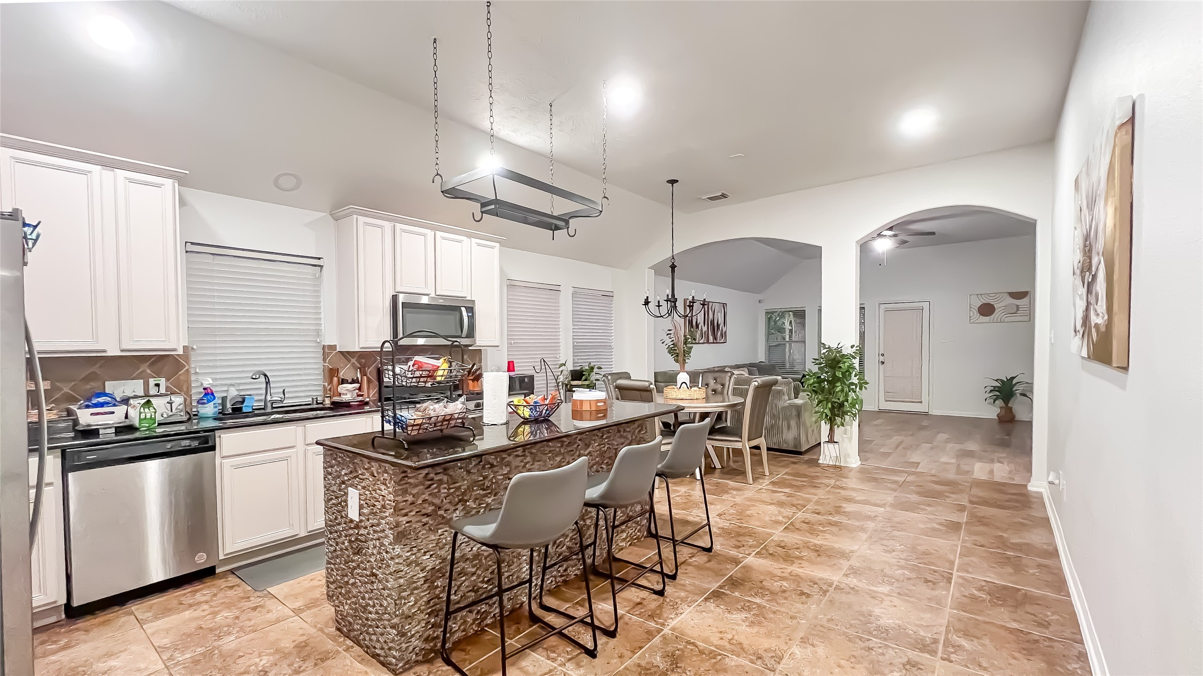 9923 Opal Rock Drive Rosharon, TX 77583 - Photo 2 of 20 a kitchen with stainless steel appliances a table and chairs in it