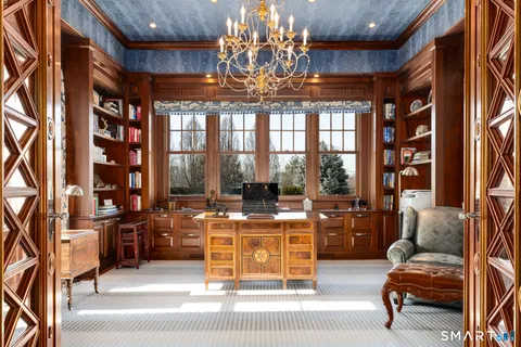 a kitchen with kitchen island a sink appliances cabinets and a large window