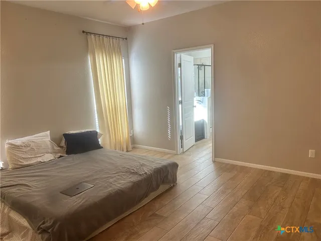 a bedroom with a bed and a window