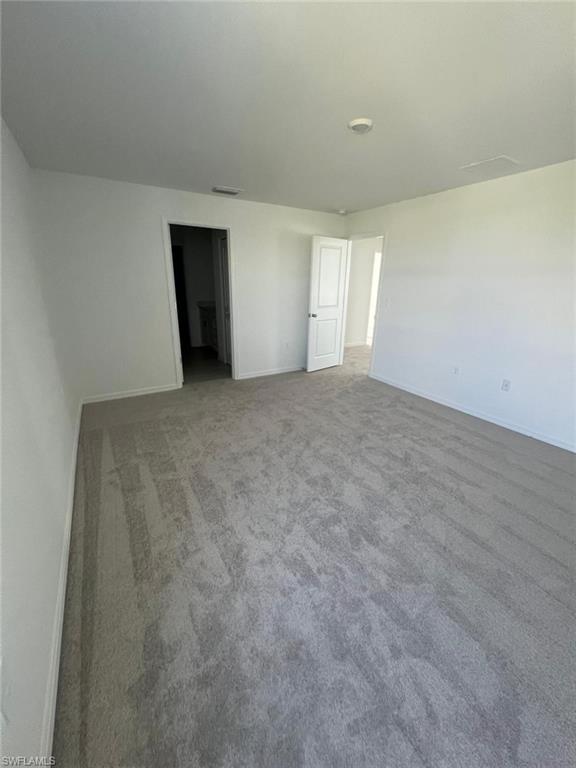 19763 Garden Rdg Court Lehigh Acres, FL 33936 - Photo 8 of 12 an empty room with windows and closet